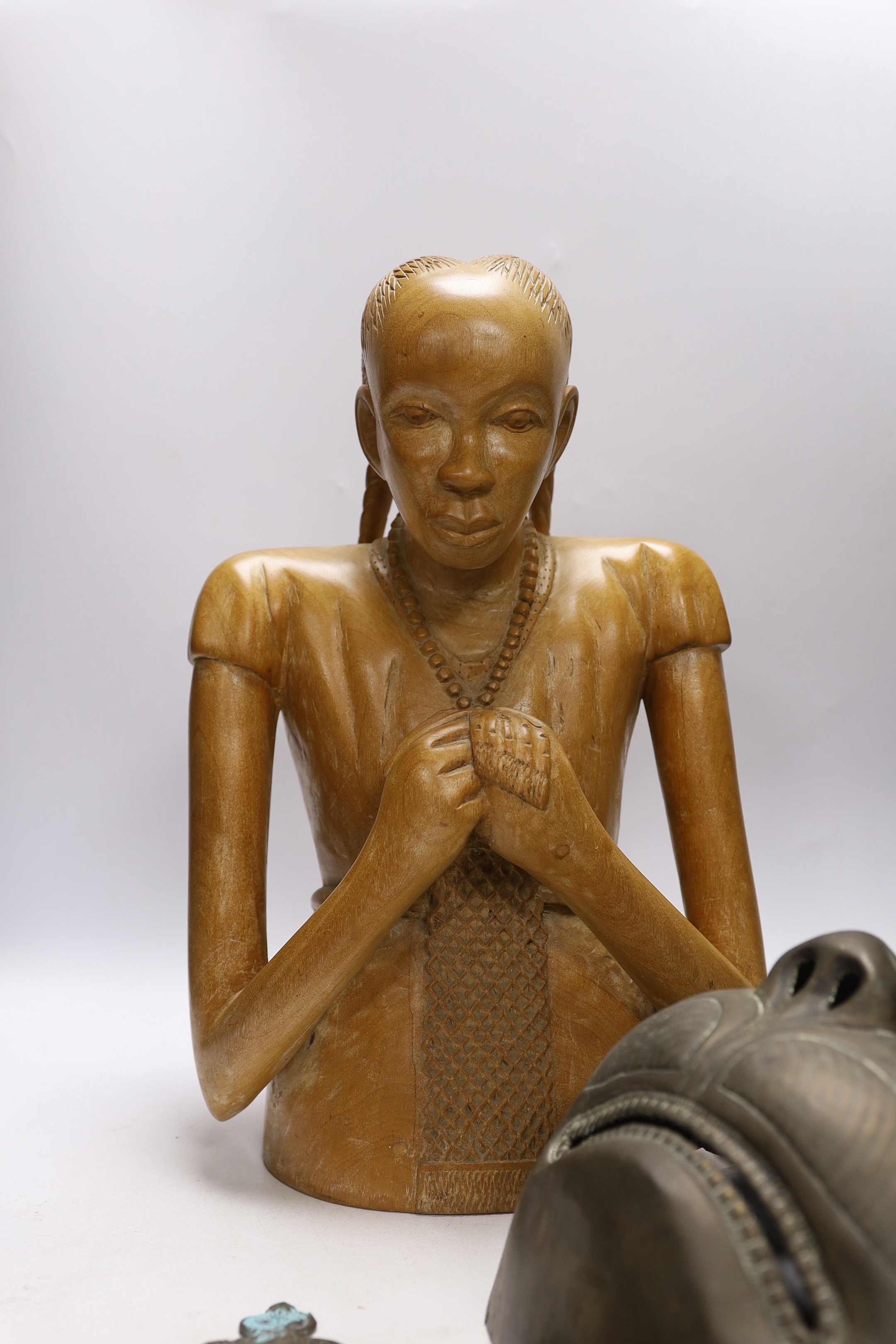 A West African carving of a girl, and a Balinese bust of a man together with an Indonesian metal mask and black lacquered spoon, mask 38cm high